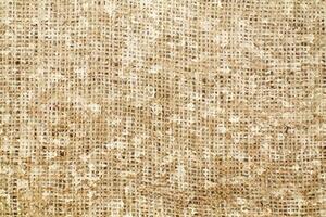 Natural Linen Material Textile Canvas Fabric Texture Background Close-up Detail of Fabric Natural Color Hemp Material Pattern Design Wallpaper. Can be Used as Background or For Graphic Design photo