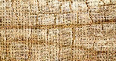 Natural Linen Material Textile Canvas Fabric Texture Background Close-up Detail of Fabric Natural Color Hemp Material Pattern Design Wallpaper. Can be Used as Background or For Graphic Design photo