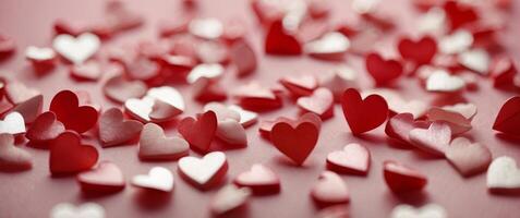 Small red shiny hearts with envelope on pink background. photo