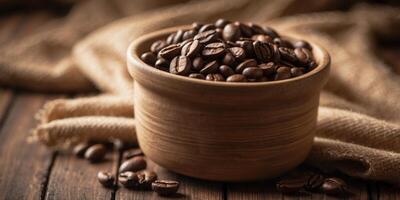 Bowl of coffee beans on rustic table with burlap sacks. photo