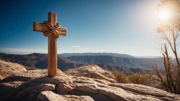 A wooden cross is in a cave with a blue sky above it. photo