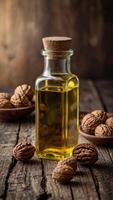 Walnut oil bottle with nuts on rustic table. photo