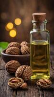 Walnut oil bottle with nuts on rustic table. photo