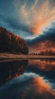 A dark blue and orange background with a reflection of the sky. photo