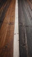 A close up of a wooden floor with a white line running down the middle. photo
