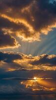 heavenly dawn breathtaking sunrise sky with dramatic rays of golden light piercing through layered clouds creating a celestial spectacle above misty landscape. photo