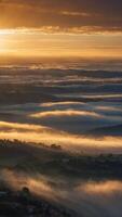 heavenly dawn breathtaking sunrise sky with dramatic rays of golden light piercing through layered clouds creating a celestial spectacle above misty landscape. photo