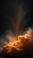A large orange cloud of dust is in the center of a black background. photo