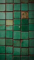 old green tiles on the wall as background. photo