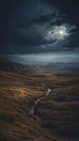 epic gloomy landscape close up moonlight breaks through heavy clouds and illuminates sections of the gloomy valley. photo