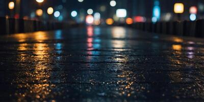 The platform is wet and the city is lit up at night. photo
