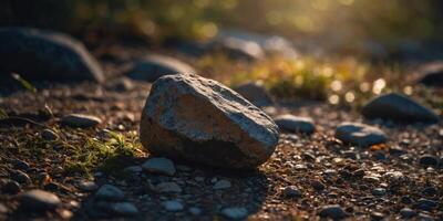 A rock is on the ground with a bright light shining on it. photo