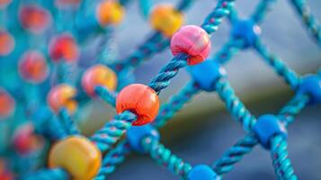 Brightly colored plastic beads adorn the ends of the cargo net adding a touch of decoration to its practical purpose. The varied colors also serve as markers for different hauling photo