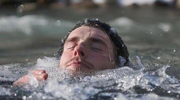 As the meditator sinks deeper into their icy bath their mind becomes still and their body relaxed embracing the transformative power of the cold water photo