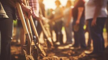 Closeup of a group of hands holding shovels and trowels, showcasing teamwork in a community service project. photo
