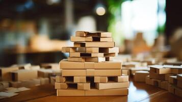 Closeup of a pile of cardboard boxes being and glued to create a functioning desk organizer. photo