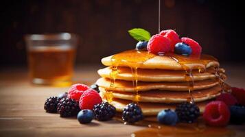 Closeup of a stack of whole grain pancakes topped with fresh berries and a drizzle of honey. photo