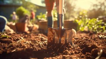 Closeup of a rake digging into the earth, helping to clear debris from a community garden. photo