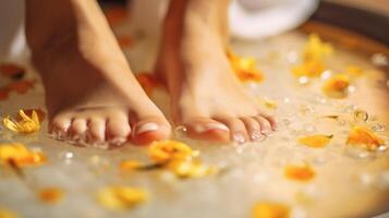 Closeup of a womans feet, soaking in a warm foot soak infused with essential oils and nourishing ingredients for soft, smooth skin. photo