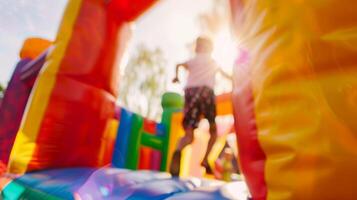 The bouncy castle is a blur of jumping and laughter under the hazy sun photo