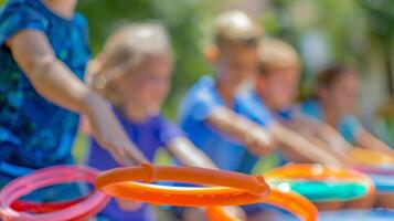 Soft focus on a group of youngsters trying their hand at a ring toss game photo