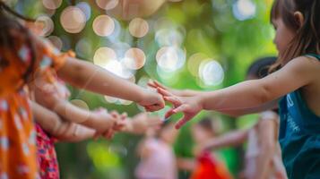 Fingers interlock as children twirl around in a game of musical chairs photo