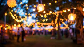 A defocused view of the festival at dusk with ling fairy lights guiding the way photo