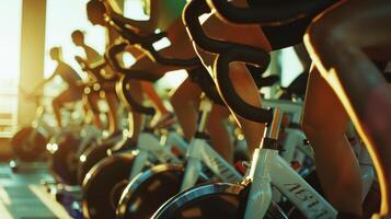A group of people doing aerobic exercises on stationary bikes the energy generated from the solar panels powering the gyms lights and fans photo