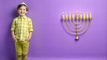 Happy boy with Hanukkah candelabra and menorah over purple background photo