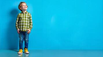 Full length portrait of a cute little boy on a blue background. photo