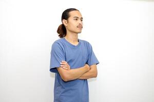 Smiling Asian man wearing dark blue t-shirt standing with arms crossed facing sideways. isolated in white background photo