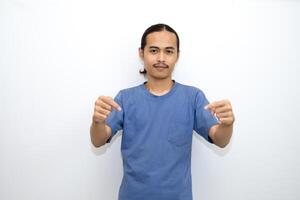 Asian man smiling with both hands pointing down. isolated on white background photo
