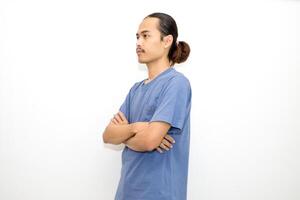 Smiling Asian man wearing dark blue t-shirt standing with arms crossed facing sideways. isolated in white background photo