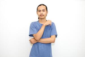 Smiling Asian man wearing dark blue t-shirt standing with arms almost touching chin facing front. isolated in white background photo