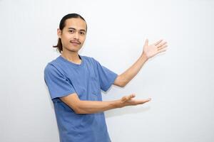Asian man smiling with both hands pointing to the side. isolated on white background photo