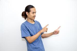Asian man smiling with both hands pointing to the side. isolated on white background photo