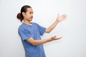 Asian man smiling with both hands pointing to the side. isolated on white background photo