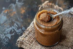 Smooth Peanut Paste Served in a Glass Jar photo