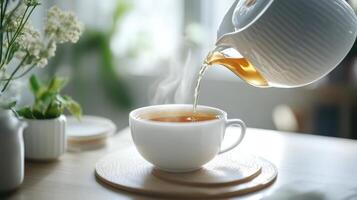 Hot Tea Being Poured into a White Mug photo