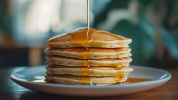 Stack of Pancakes with Maple Syrup on a Plate photo