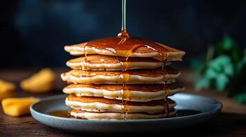 Stack of Pancakes with Maple Syrup on a Plate photo