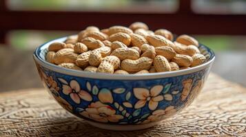 Decorative bowl filled with sweet peanut candies on a table. photo
