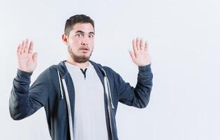 Scared man with raised hands isolated. Person with scared face with raised hands photo