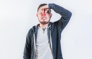 Guy suffering with nasal bridge on isolated background. Suffering man with nasal bridge pain isolated photo