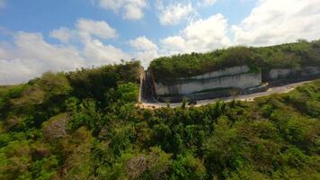 FPV flight over the road in cliffs near Batu Barak beach in Bali, Indonesia video