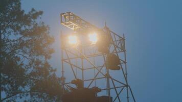 Illuminated Lighting Tower in Misty Environment video