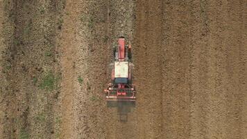 Top view of tractor sowing grain in the farm field. video