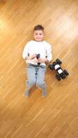 vertical boy lying on his back controls toy rc car with a remote control video