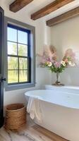 A modern bathroom features a white freestanding tub, wood trim, and a window photo
