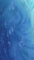 Abstract liquid effect background with flowing ripping waves and swirls. Smooth fluid motion creates a serene calming atmosphere. Tranquil water texture. Full HD and looping vertical background. video